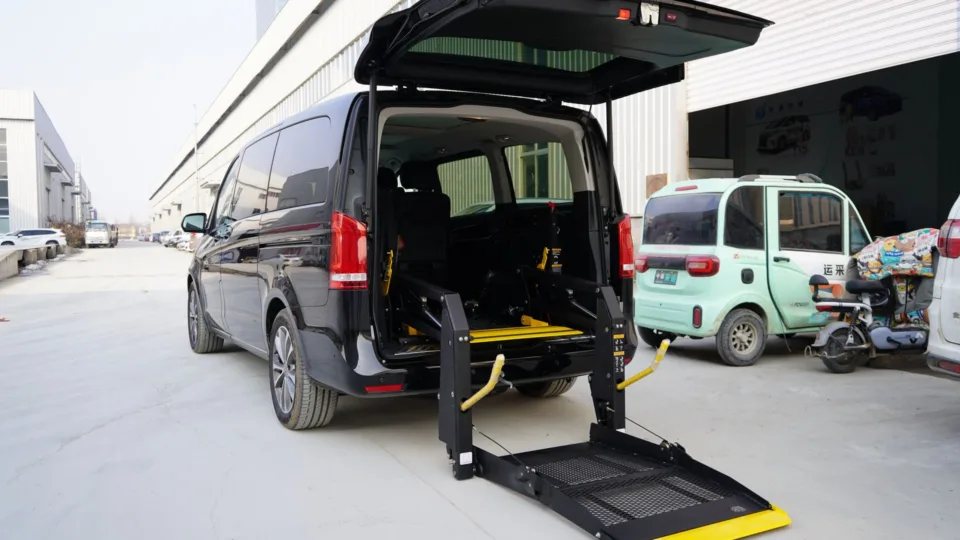 Wheelchair-accessible vehicle, black van with a rear wheelchair lift lowered